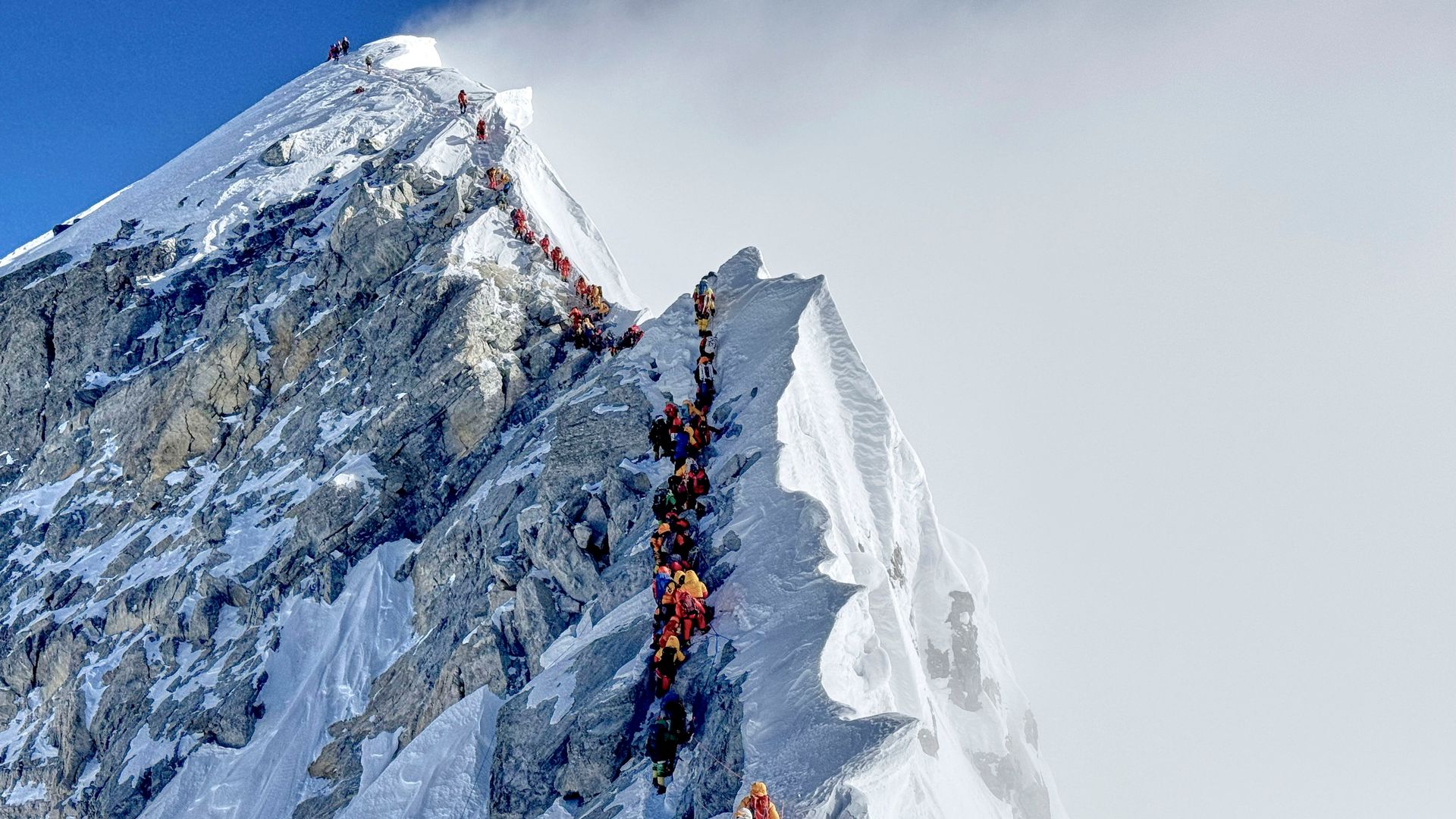 Mount Everest suffers traffic jams as climbers battle harsh weather – with beginners not helping